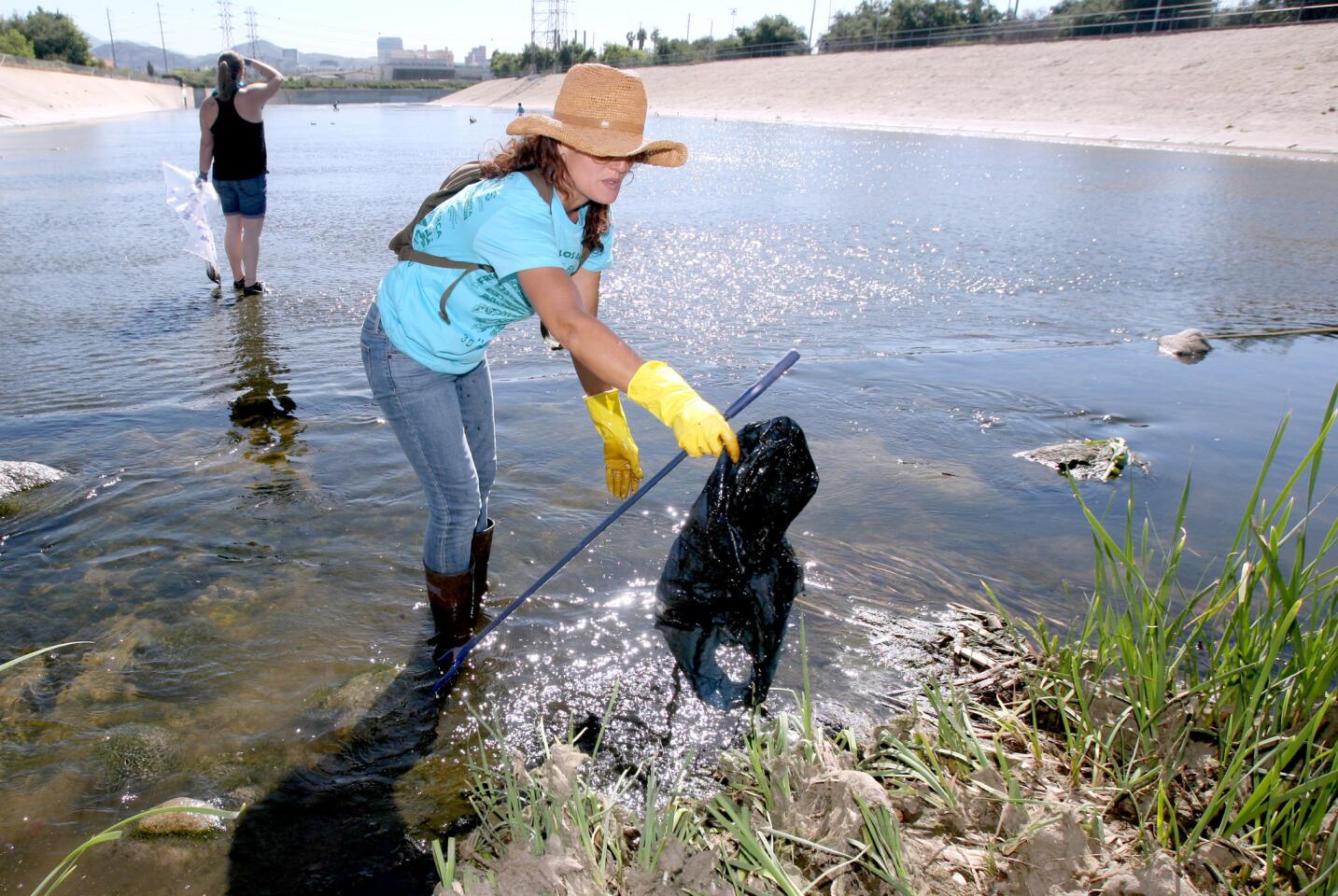 Gesa Engel, 44 of Los Angeles, removed plastic and other trash from the Los Angeles River during clean-up event sponsored by the Friends of the L.A. River, at Glendale Narrows Riverwalk in Glendale, on Saturday, April 16, 2016. Hundreds of volunteers fanned out throughout a mile stretch of the river and removed tons of trash.