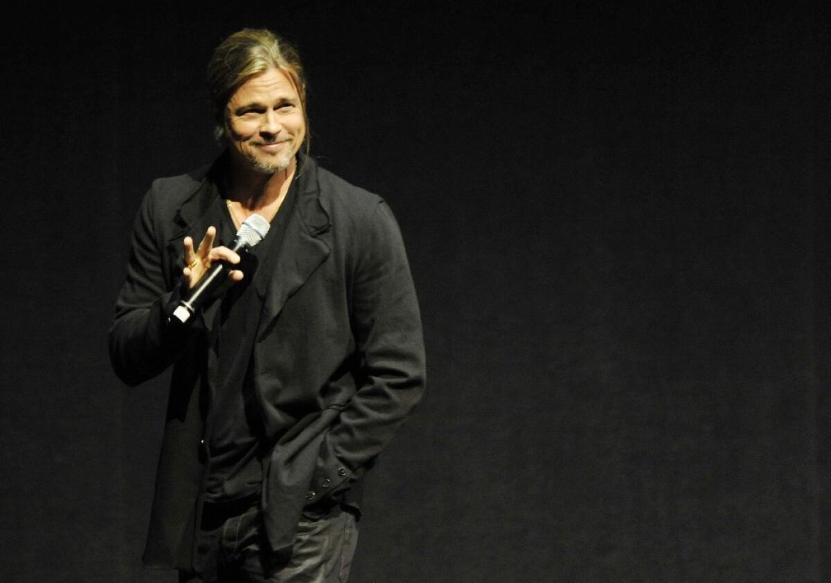 Brad Pitt introduces footage from his upcoming film "World War Z" on opening night at CinemaCon in Las Vegas.
