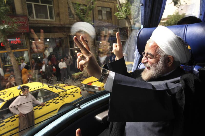 Iranian President-elect Hasan Rouhani waves to supporters.