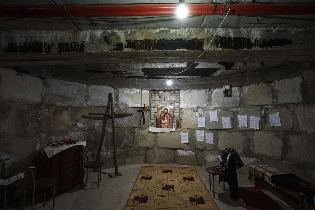 Crosses and an image of the Holy Family decorate an underground chapel.