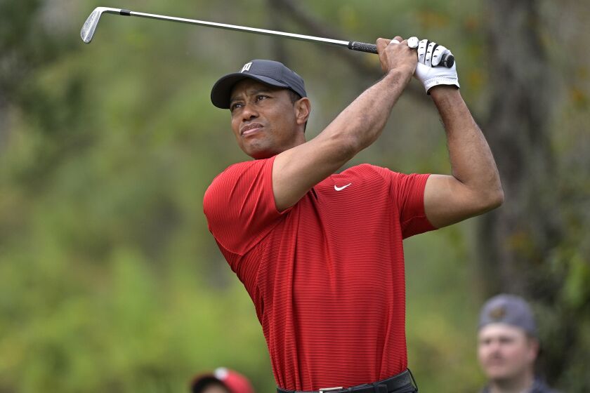 FILE - Tiger Woods watches his tee shot on the fourth hole during the final round.