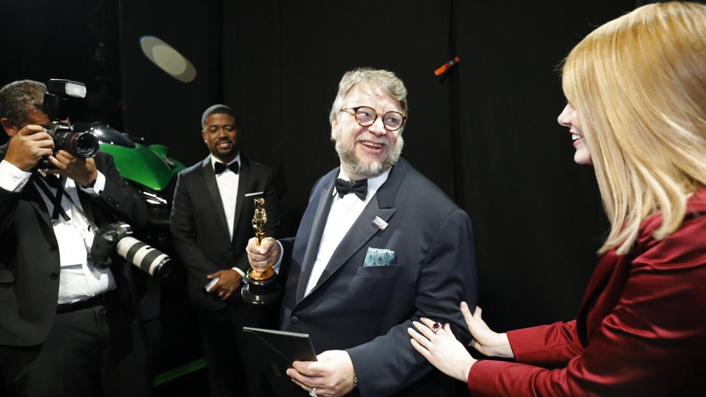 Guillermo del Toro after winning for best director and presenter Emma Stone backstage at the 90th Academy Awards on Sunday at the Dolby Theatre in Hollywood.