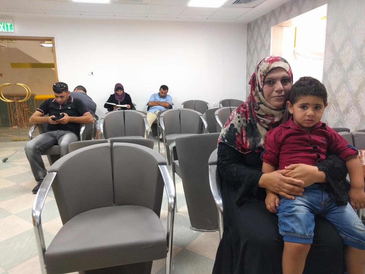 Fathiya Safadi sits in the Razan fertility clinic's waiting room in the West Bank town of Nablus with son Amir, who was conceived using seminal fluid from her husband, Ashraf, that was smuggled out of an Israeli prison.