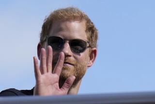 FILE - Britain's Prince Harry, The Duke of Sussex, waves during the Formula One U.S. Grand Prix auto race at Circuit of the Americas, on Oct. 22, 2023, in Austin, Texas. A British judge ruled Friday that a lawsuit by Prince Harry, Elton John and five other celebrities accusing a newspaper publisher of unlawful information-gathering should go to a full trial. The claimants, who include John’s husband David Furnish and actors Liz Hurley and Sadie Frost, accuse the publisher of the Daily Mail of paying private investigators to illegally bug homes and cars and to record phone conversations. (AP Photo/Nick Didlick, File)