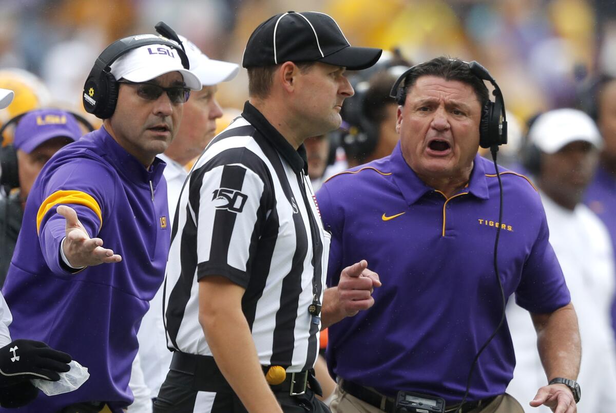 LSU coach Ed Orgeron, right, challenges an official during a game against Auburn in October.