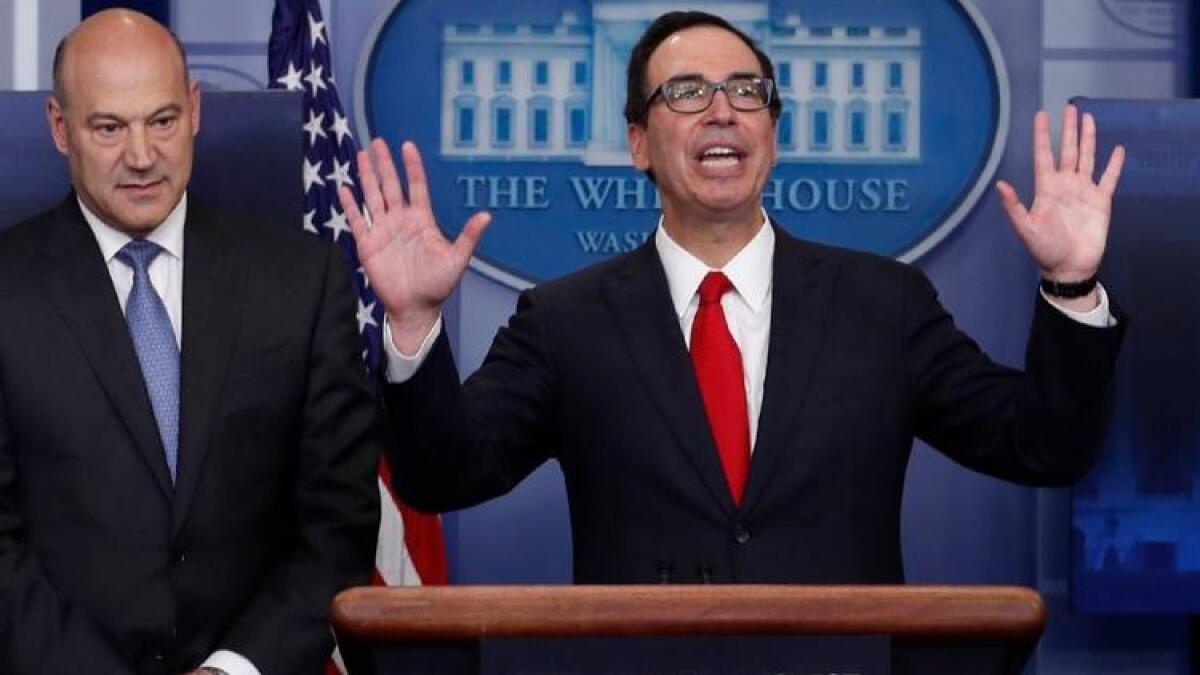 Gary Cohn, director of the National Economic Council, left, joins Treasury Secretary Steven Mnuchin in the White House briefing room on Wednesday.