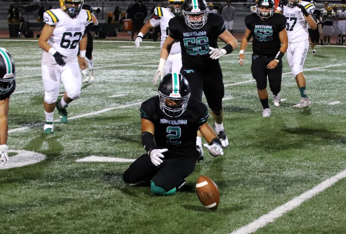 Costa Mesa's Victor Dominguez (2) recovers a fumble against Saddleback in an Orange Coast League game at Costa Mesa High.