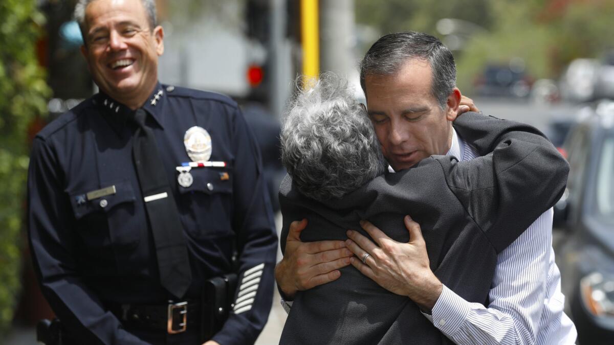 Los Angeles Police Commissioner Sandra Figueroa-Villa hugs Mayor Eric Garcetti