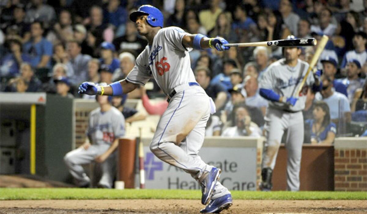 Yasiel Puig hits a home run (11) in the ninth inning of the Dodgers' 6-4 victory over the Chicago Cubs at Wrigley Field on Thursday.