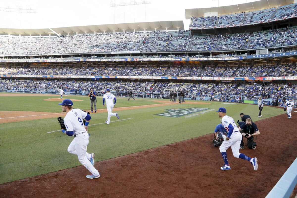 Dodgers players take the field at Dodger Stadium before Game 4 of the NLCS.