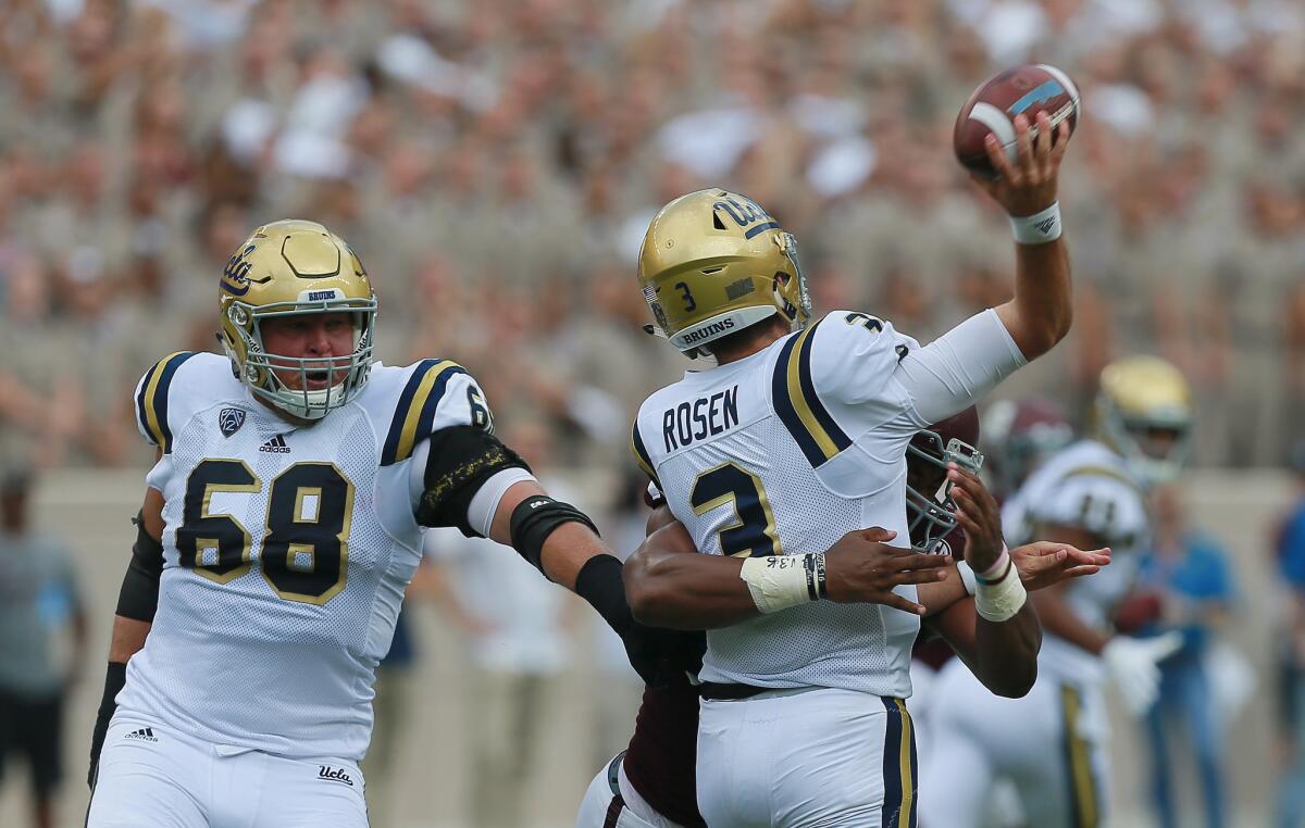 UCLA quarterback Josh Rosen takes a hit from Texas A&M defensive end Myles Garrett, who beat Bruins offensive lineman Conor McDermott (68), on the play.