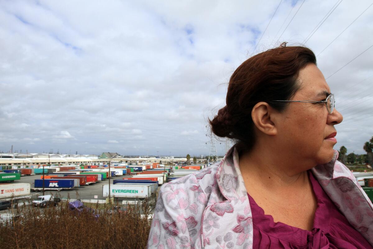 Carmen River, 52, an opponent of the Southern California International Gateway, stands across from the site of the proposed rail yard. The facility would be built next to a west Long Beach neighborhood that could be impacted by its construction.