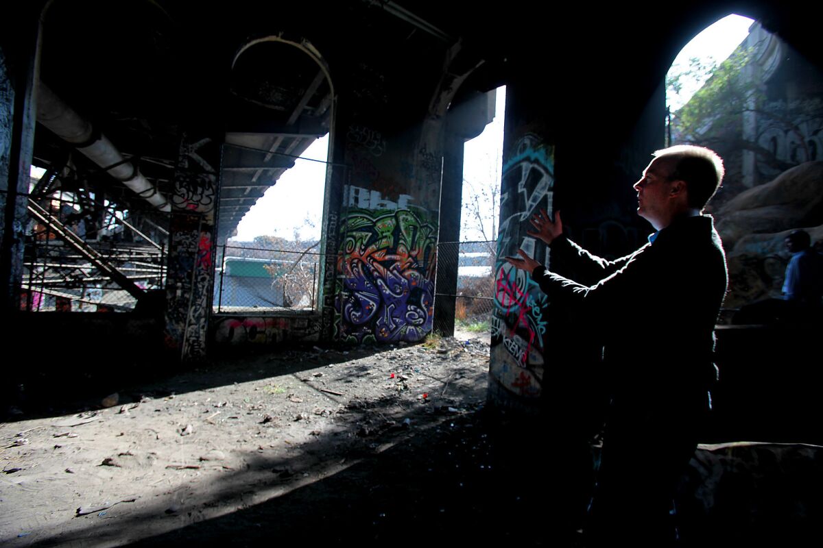 Preservationist and architect Kevin Mulcahy under the concrete and steel Riverside Drive Bridge on Jan. 10 in Los Angeles.