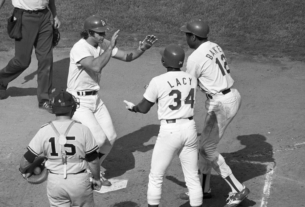 Steve Yeager, left, celebrates with Dodgers teammates Lee Lacy and Dusty Baker after hitting a three-run home run.