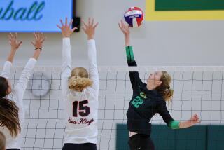 Mira Costa's Audrey Flanagan lofts the ball over a pair of Palos Verdes blockers.