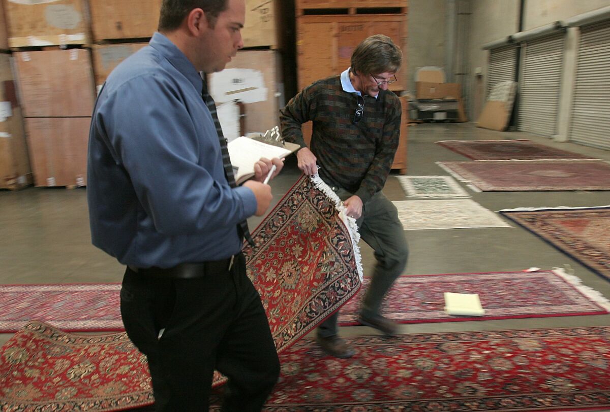 This rug and others like it, along with several pieces of furniture that were the ill-gotten gains of ex-Congressman Randall "Duke" Cunningham, were displayed to the media in a Poway warehouse in 2006. — John Gastaldo