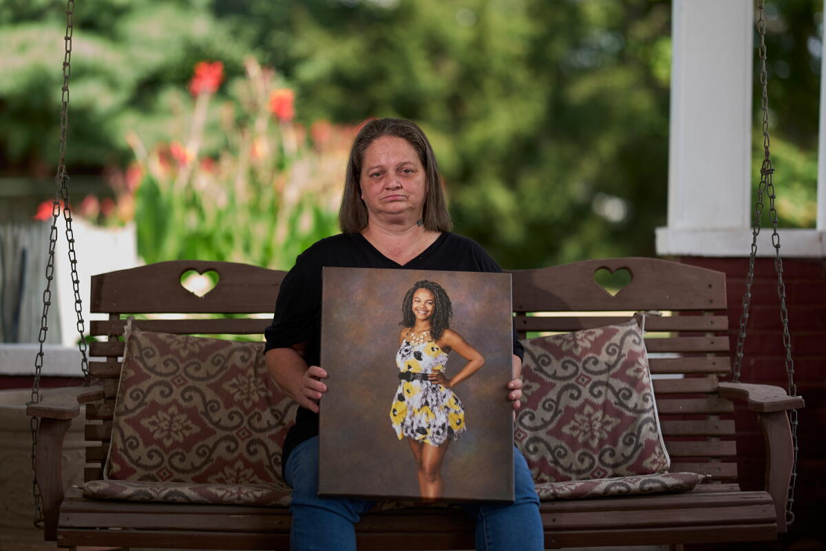 Christy Spivey poses with a portrait of her late daughter, Tasia Fortune, in Marion, Ky.