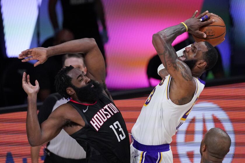 Los Angeles Lakers' LeBron James, right, shoots over Houston Rockets' James Harden (13) during the second half of an NBA conference semifinal playoff basketball game Tuesday, Sept. 8, 2020, in Lake Buena Vista, Fla. (AP Photo/Mark J. Terrill)