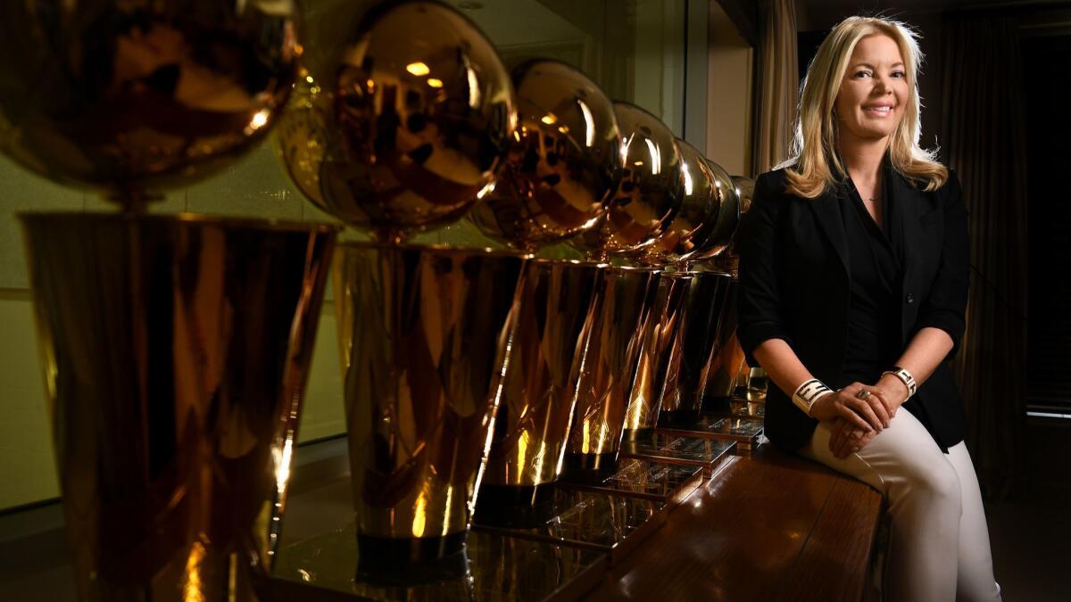 Lakers owner Jeanie Buss sits next to the team's NBA title trophies in her office in El Segundo.