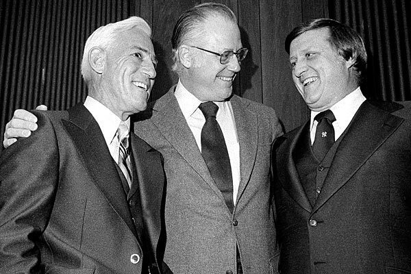 Baseball Commissioner Bowie Kuhn, center, smiles with Cincinnati Reds Manager Sparky Anderson, left, and New York Yankees owner George Steinbrenner at Shea Stadium in January 1977. See full story