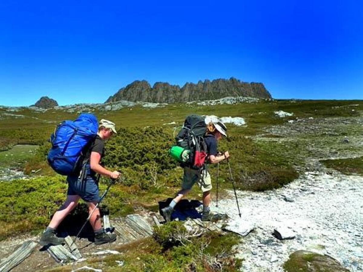 Ange Cunningham, left, and Mike Hitchcock follow the Overland Track on the first day of a six-day hike on Tasmania with the travel company Anthology.
