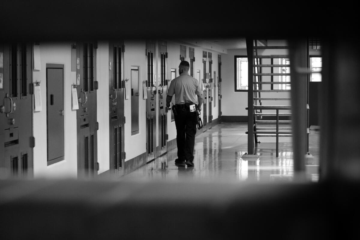 A guard on security rounds at Adelanto Detention Facility.