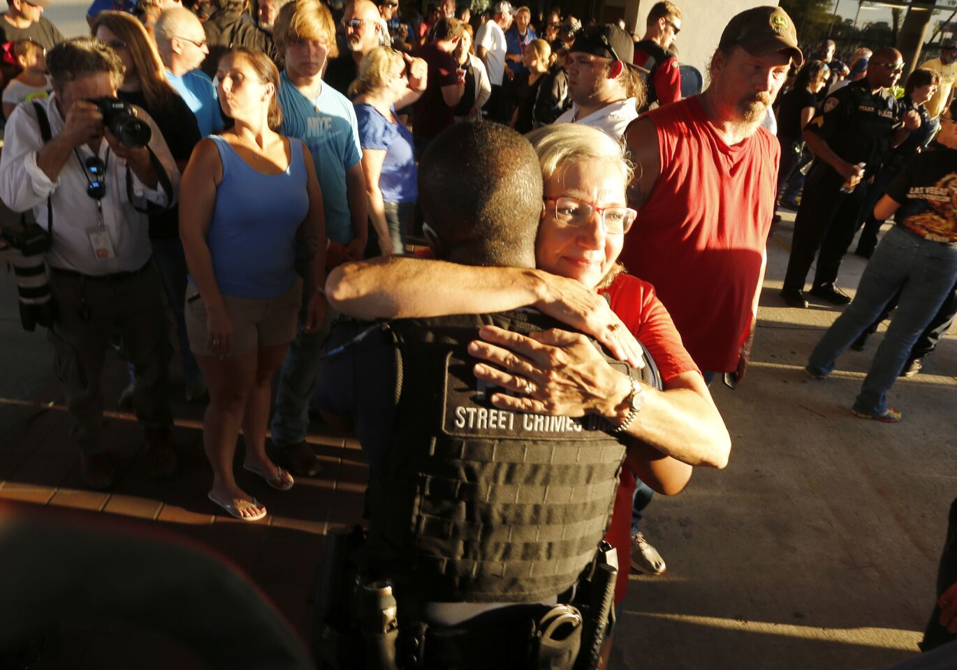 A supporter hugs a Baton Rouge police officer after a rally that included hundreds of motorcyclists.