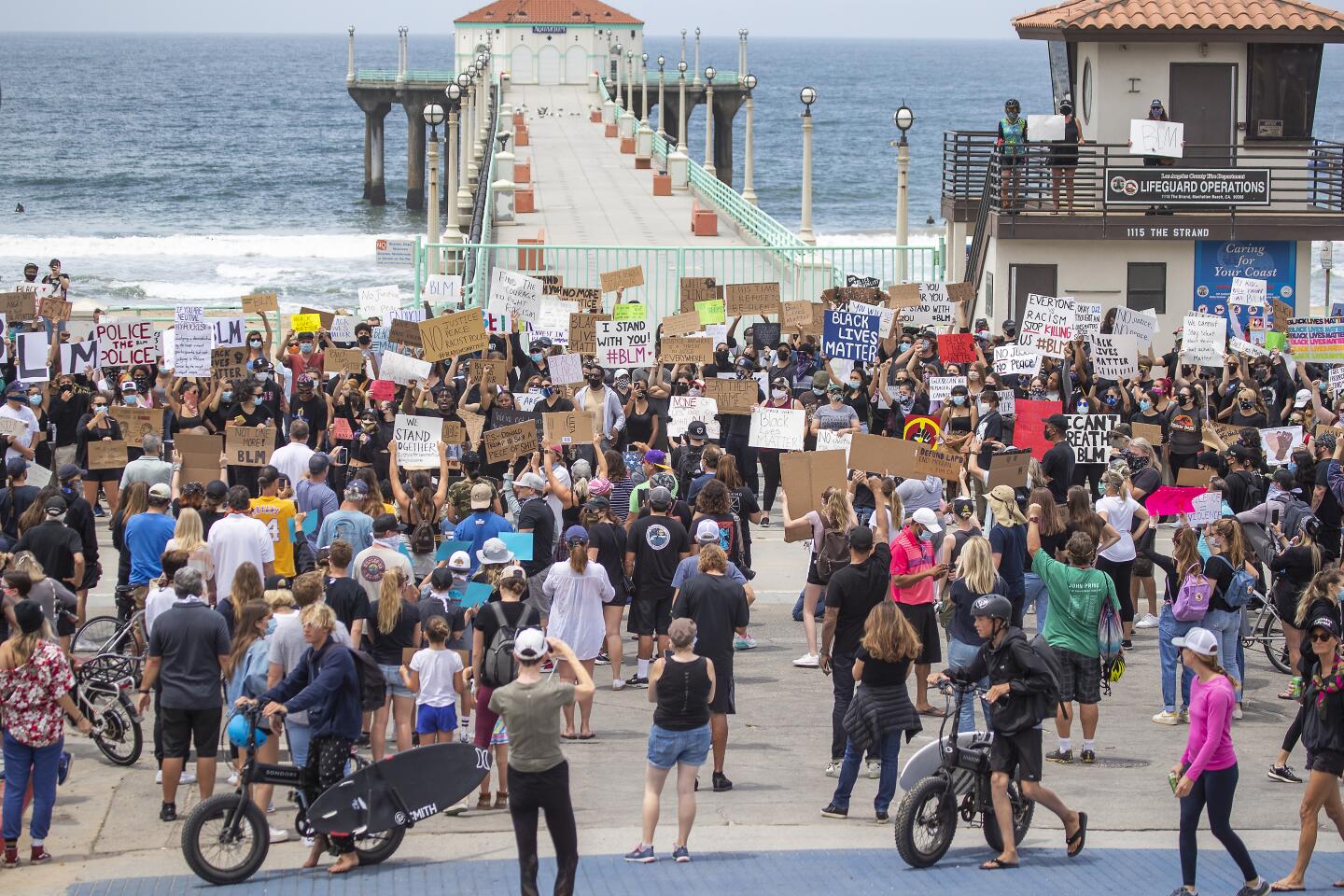 Several hundred protesters gather to demand justice for George Floyd at the Manhattan Beach Pier Plaza