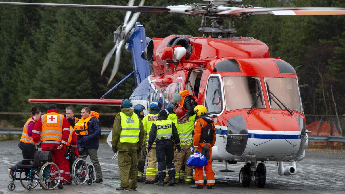 Crews remove Viking Sky passengers from a rescue helicopter in Fraena, Norway, on Sunday.