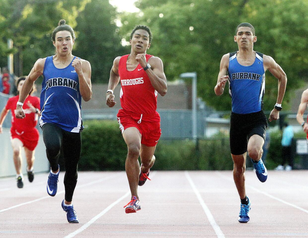 Burbank's Ian Miller, Burroughs' Caleb Black and Burbank's Bryan David run together to the finish of the boys' 200 in a Pacific League dual track meet between Burroughs and Burbank at Memorial Field in Burbank on Thursday, April 11, 2019.