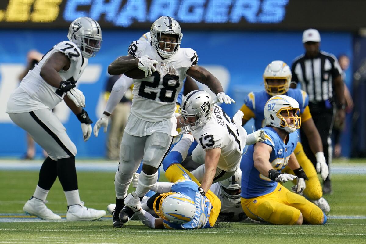 Raiders running back Josh Jacobs carries the ball against the Chargers in the second half.