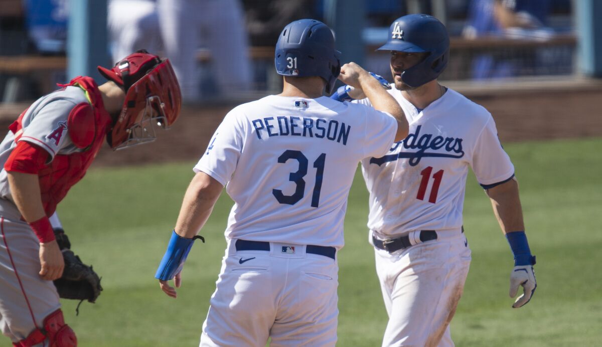 Dodgers center fielder AJ Pollock celebrates his two-run home run with Joc Pederson.