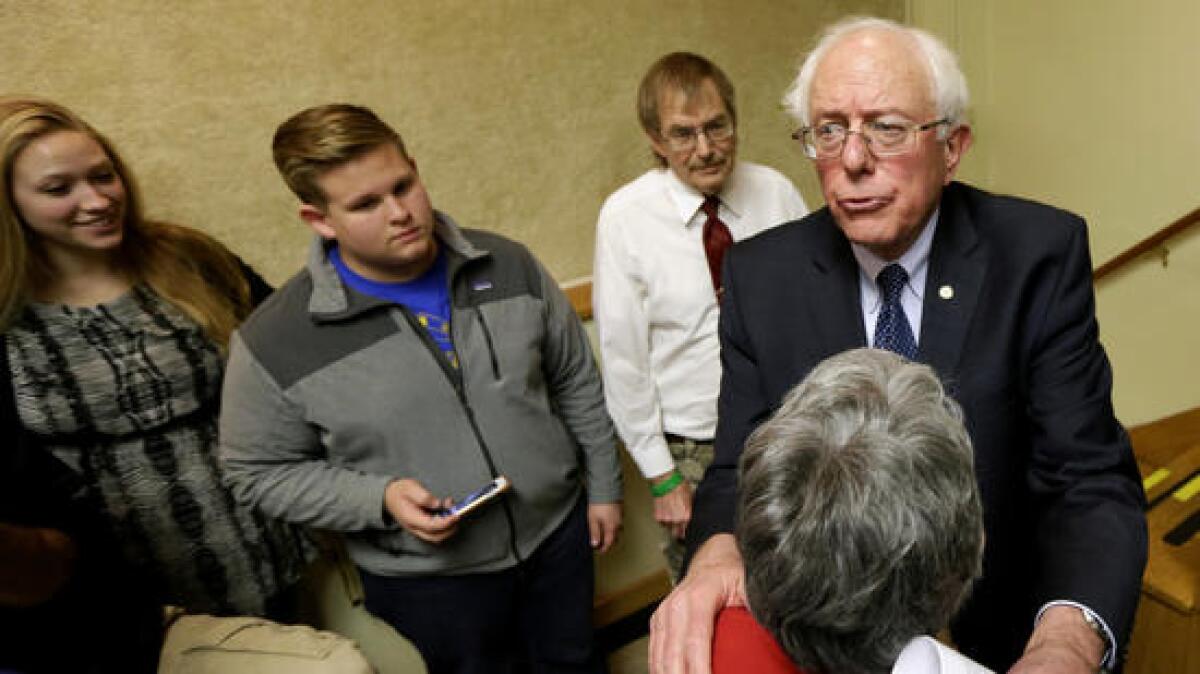 Sen. Bernie Sanders (I-Vt.) talks with local residents after a town hall meeting in Ames, Iowa, on Dec. 16, 2014.