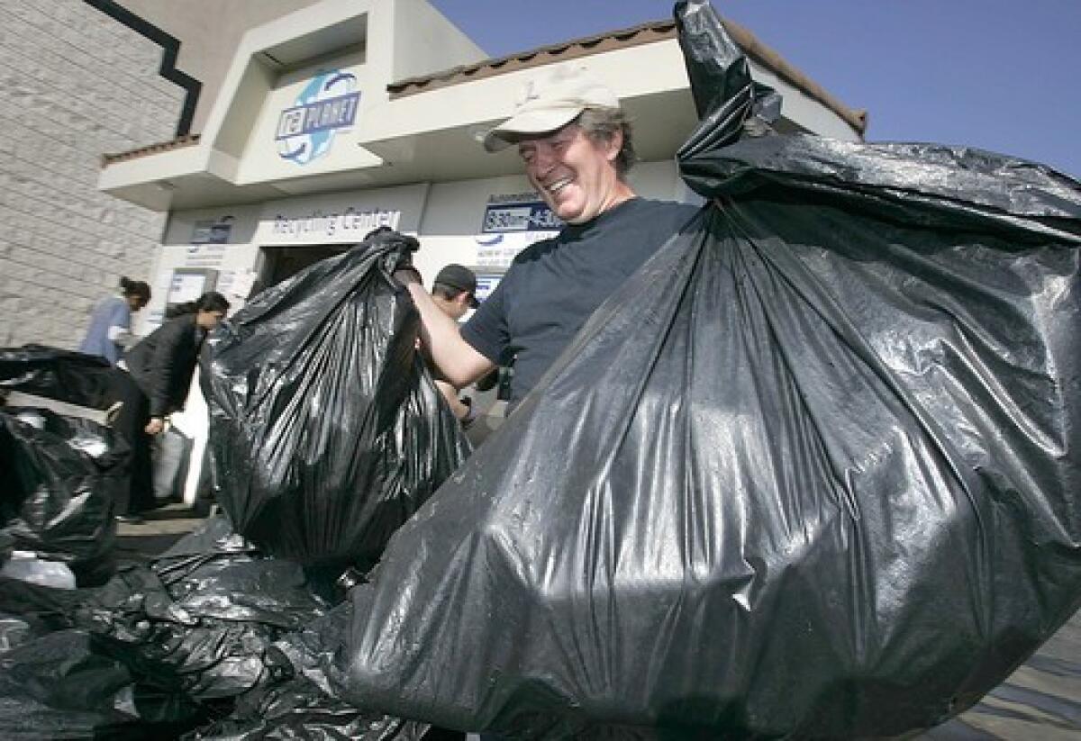 FULL LOAD: Wolfgang Braendle, at a recycling center in L.A., has been a recycling devotee for 2 1/2 years. Some days, he spends up to eight hours gathering and turning in recyclables from neighbors and friends who don't have the time or aren't willing to go to centers.