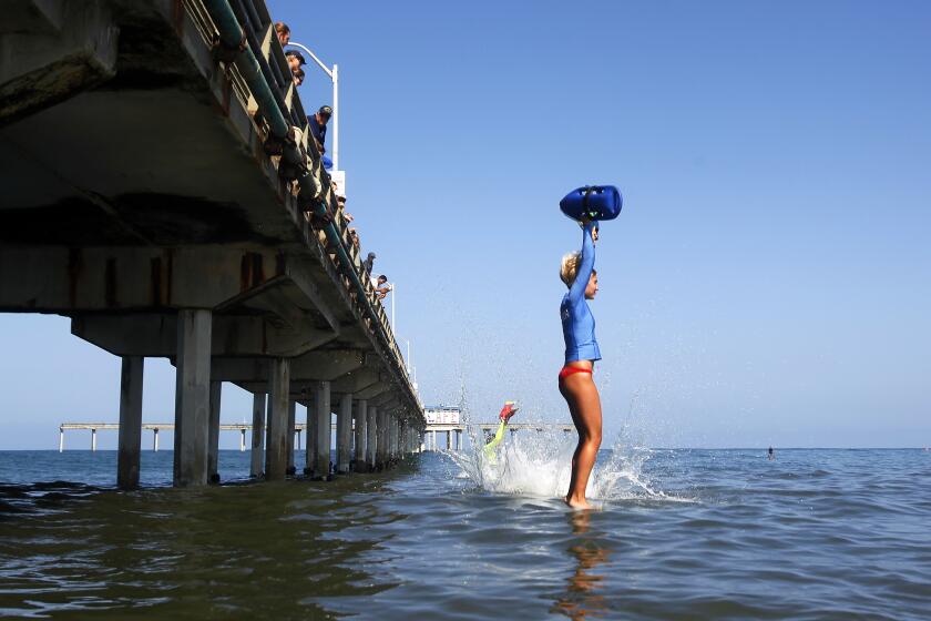 A San Diego Junior Lifeguards intern lands in the water after jumping off the Ocean Beach Municipal Pier at the end of their four week summer training on Monday, August 13, 2018. Parents and the public were also invited to pay a fee and make the leap with proceeds going to the Prevent Drowning Foundation of San Diego. (Photo by K.C. Alfred/San Diego Union-Tribune)