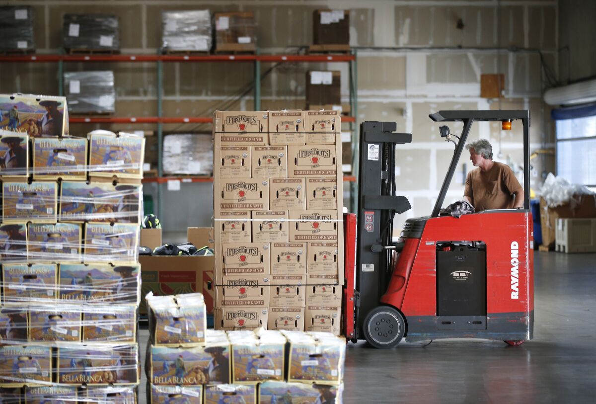 Bill McLeod moves some of the 5,880 pounds of fresh apples that was donated to Feeding San Diego on June 20, 2019. The apples were donated by Charlie's Produce to Barons Market, who then picked Feeding San Diego as a way to distribute the food, which will end up with families in facing food insecurity in Southern California.