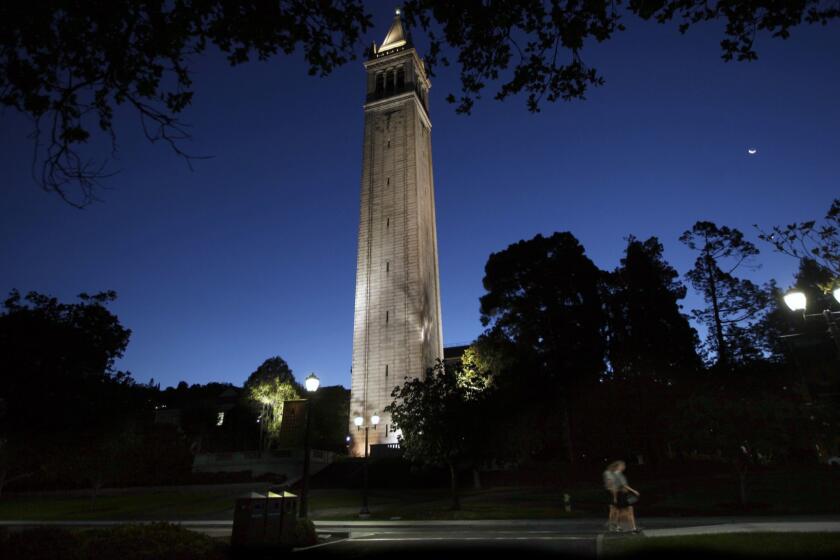 BERKELEY, CA - SEPTEMBER 09, 2015: Early morning joggers pass the Campanile on the campus of the University of California at Berkeley before the sun came up on SEPTEMBER 09, 2015. ( Bob Chamberlin / Los Angeles Times )