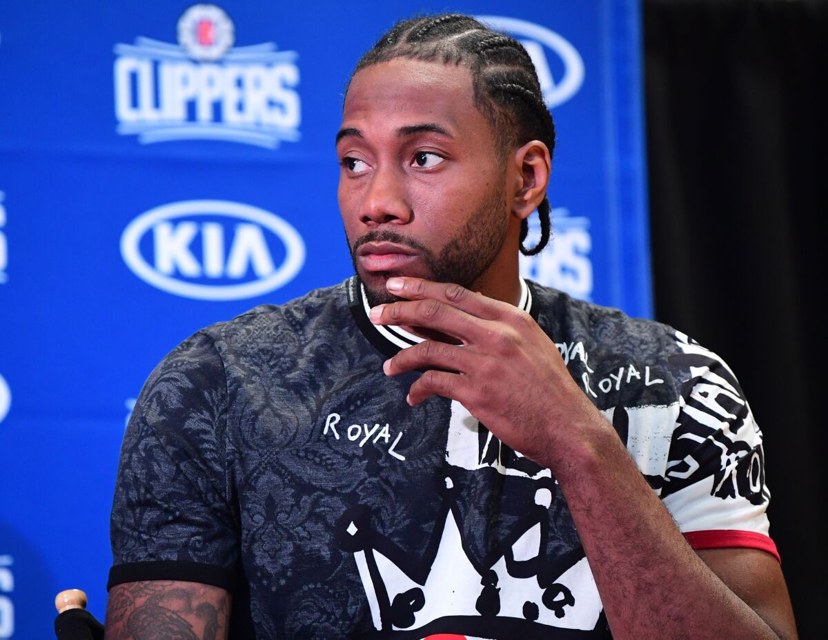Kawhi Leonard, speaking at a news conference July 24 in Los Angeles, was among several big NBA stars who didn't compete in China.