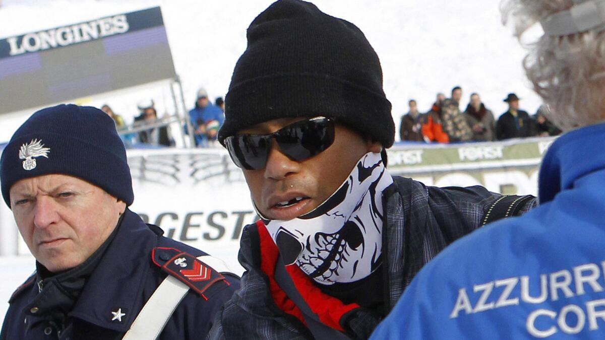 Tiger Woods attends a super-G race in Italy on Jan. 19, 2015 in support of his girlfriend, Lindsey Vonn, who set a World Cup record for most career wins. The golfer lost a tooth when a camera hit him in the face, his agent says.