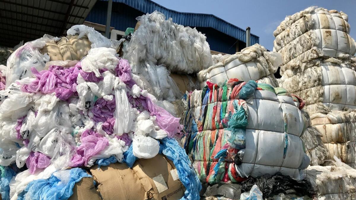 Bales of plastic are stacked outside a recycling plant in Port Klang, Malaysia.