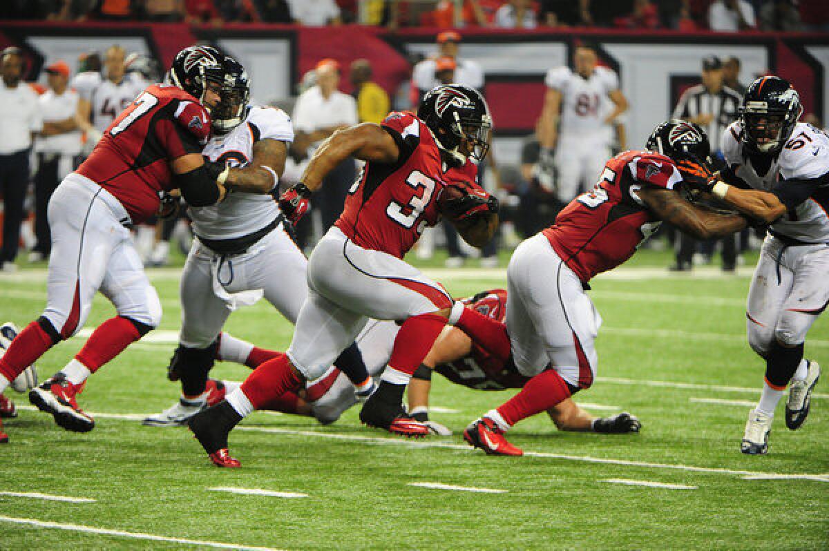 Michael Turner of the Atlanta Falcons carries the ball Monday night against the Denver Broncos.