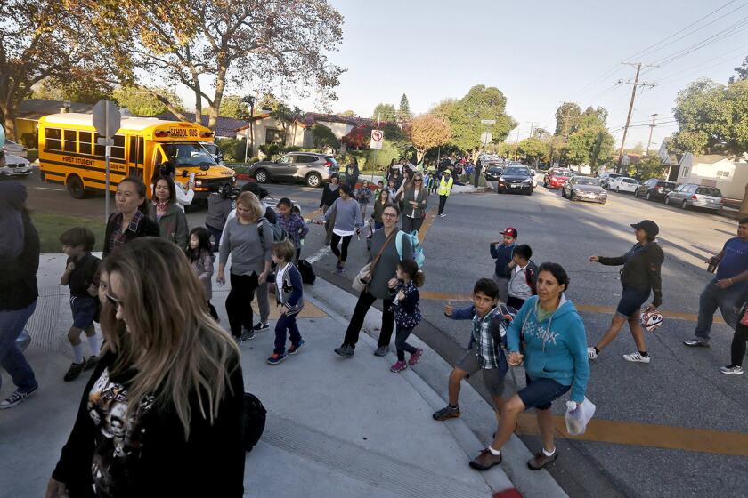 Large crowds of students and parents walk toward Keppel Visual and Performing Arts Magnet, Toll Middle School and Hoover High School on International Walk to School Day in Glendale on Wednesday, Oct. 4, 2017.