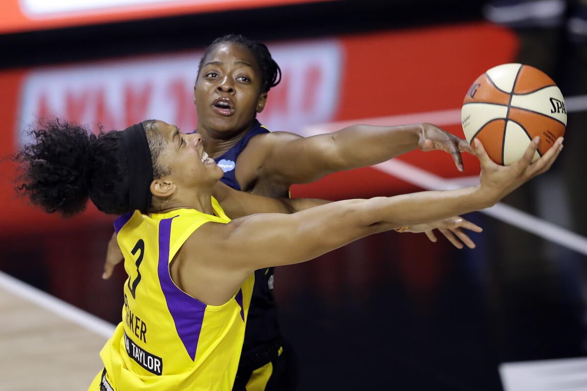 Sparks forward Candace Parker goes for a layup around Indiana Fever forward Stephanie Mavunga.