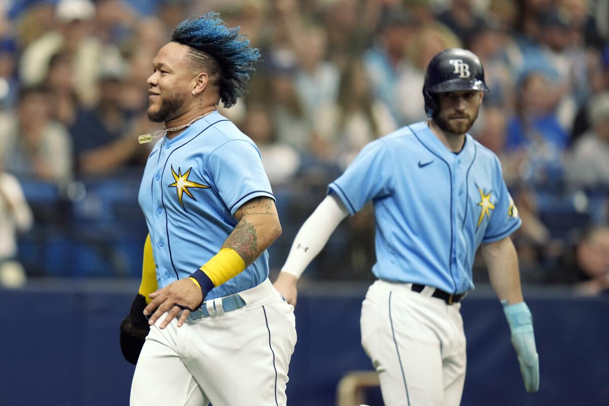 Tampa Bay's Harold Ramirez, left, and Brandon Lowe celebrate after scoring on a two-run double by Isaac Paredes.