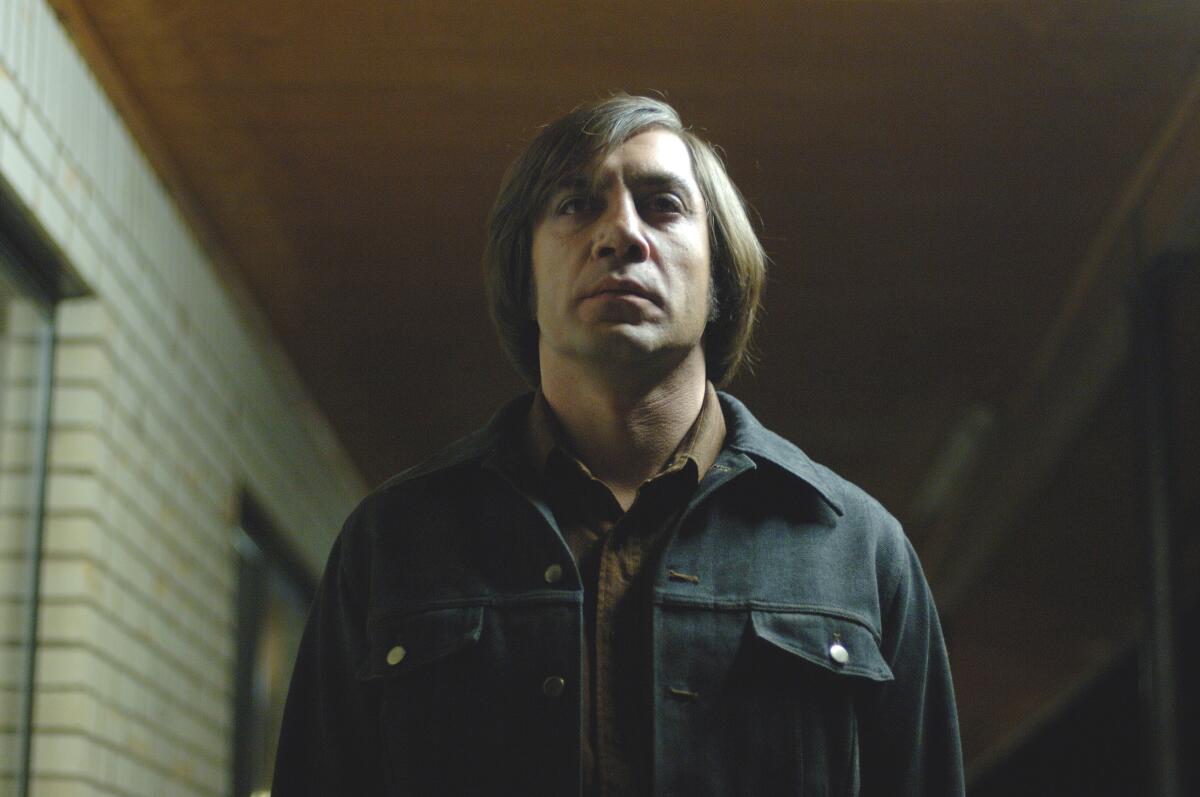Javier Bardem stares straight ahead in a scene from “No Country for Old Men”