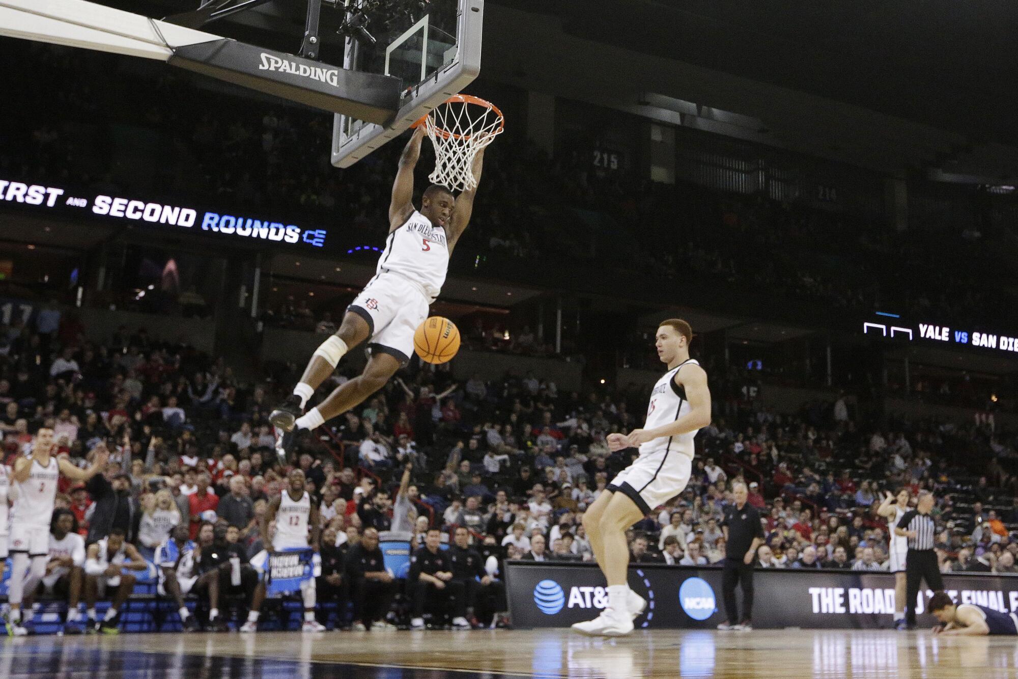 San Diego State guard Lamont Butler (5) dunks during an NCAA tournament game against Yale in Spokane, Wash., Sunday.