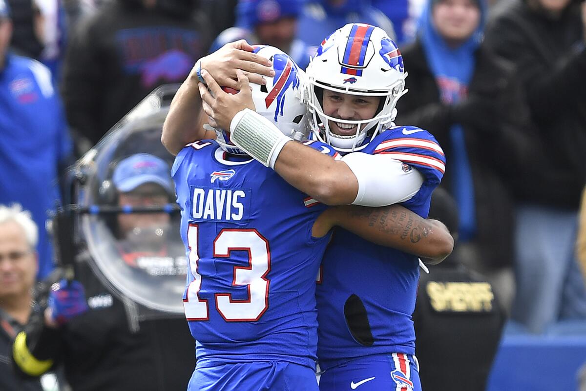 Buffalo Bills quarterback Josh Allen, right, celebrates a touchdown with wide receiver Gabe Davis (13) during the first half of an NFL football game against the Pittsburgh Steelers in Orchard Park, N.Y., Sunday, Oct. 9, 2022. (AP Photo/Adrian Kraus)