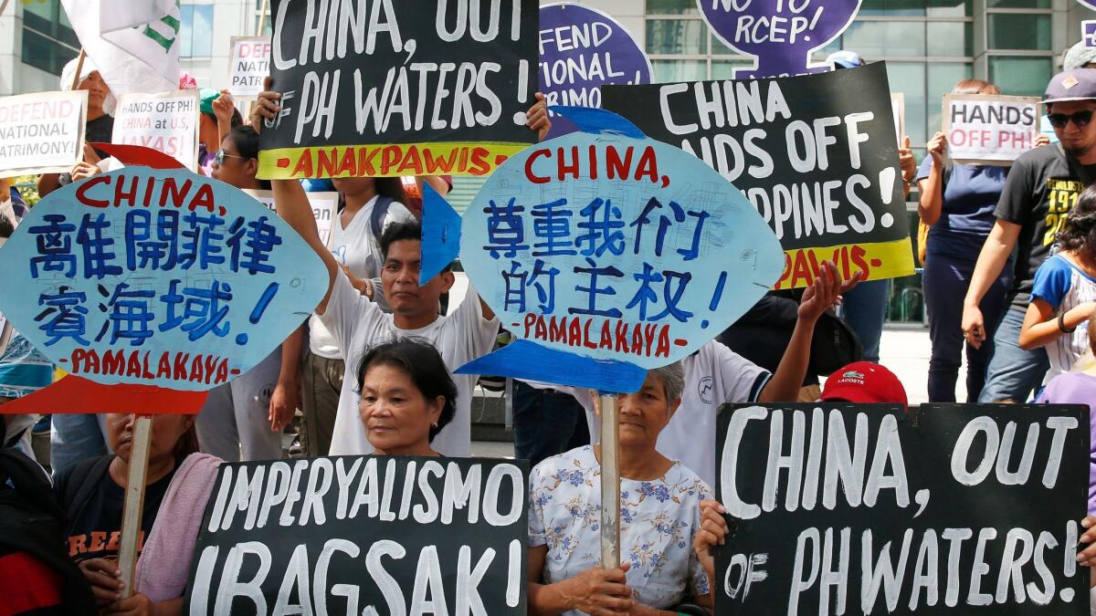 Protesters rally this week at the Chinese Consulate in Makati, Philippines, to protest China's artificial island-building at the disputed islands, reefs and shoals off the South China Sea.