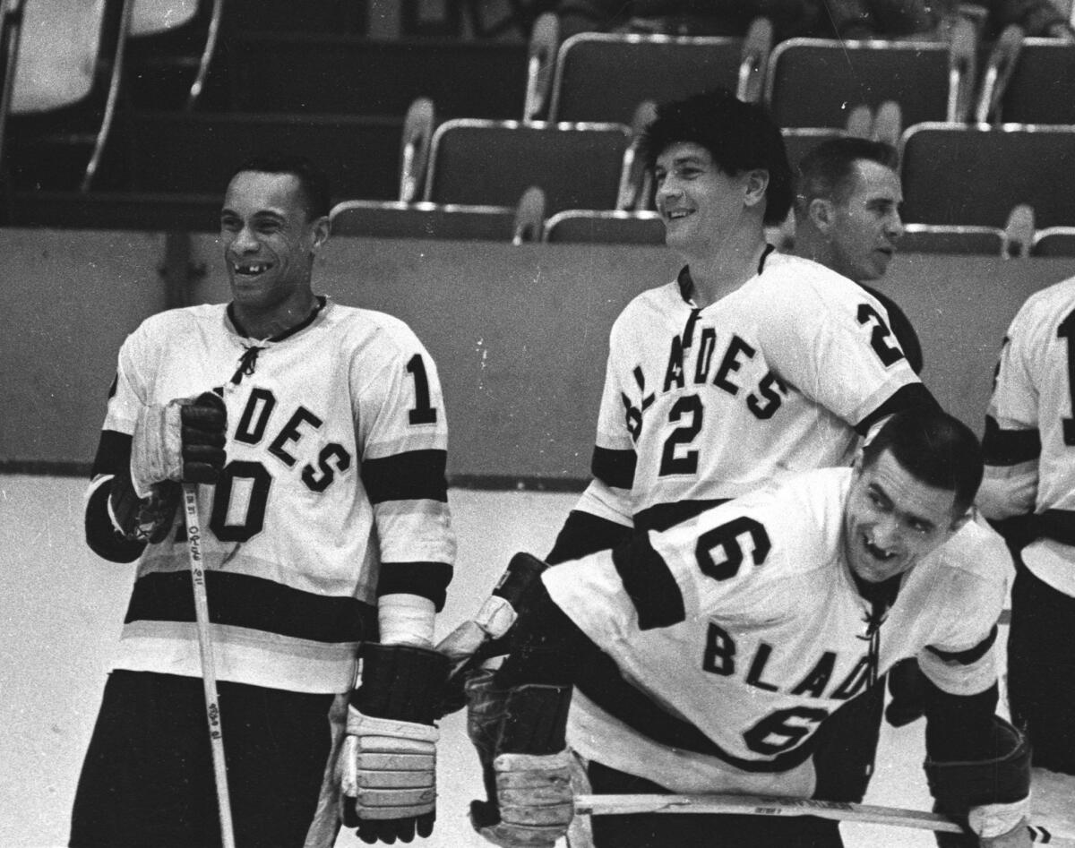 Willie O'Ree (10) and Howie Young (2) talk during warmups before a Los Angeles Blades game at the Sports Arena during the 1963-64 season.