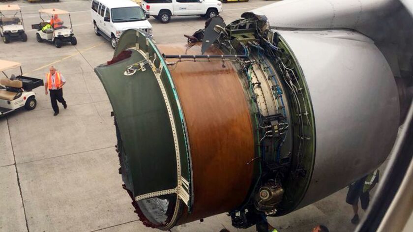 This photo provided by passenger Haley Ebert shows damage to an engine which had its cover break apart mid-flight Tuesday.
